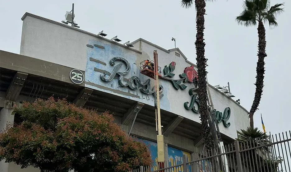 worker refurbishing historic marquee sign
