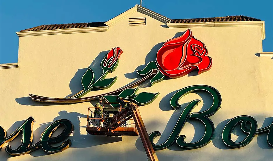 worker refurbishing historic marquee sign